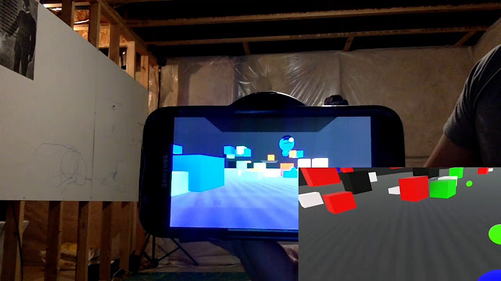 A tracked phone displays a shared virtual environment